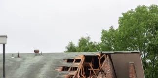 Uszkodzony budynek z zawaloną częścią dachu jako ilustracja odpowiedzialności inwestora za szkody budowlane